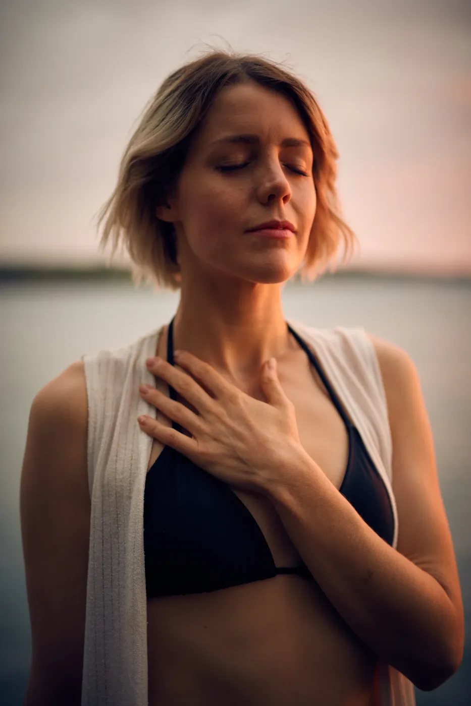 Hand resting on heart, noticing signs of low self-worth with kindness